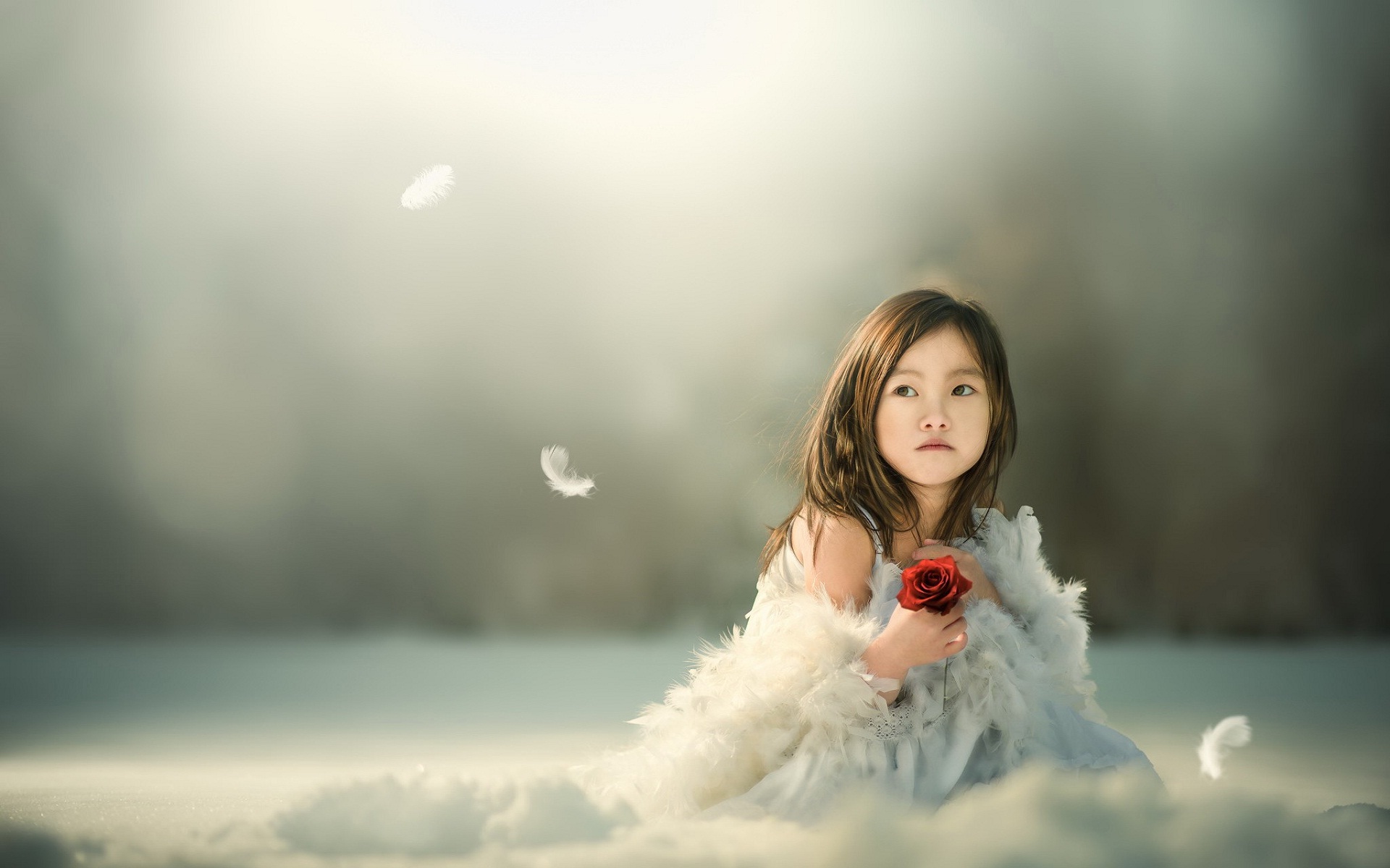 Innocent sad mood cute small girl with red rose